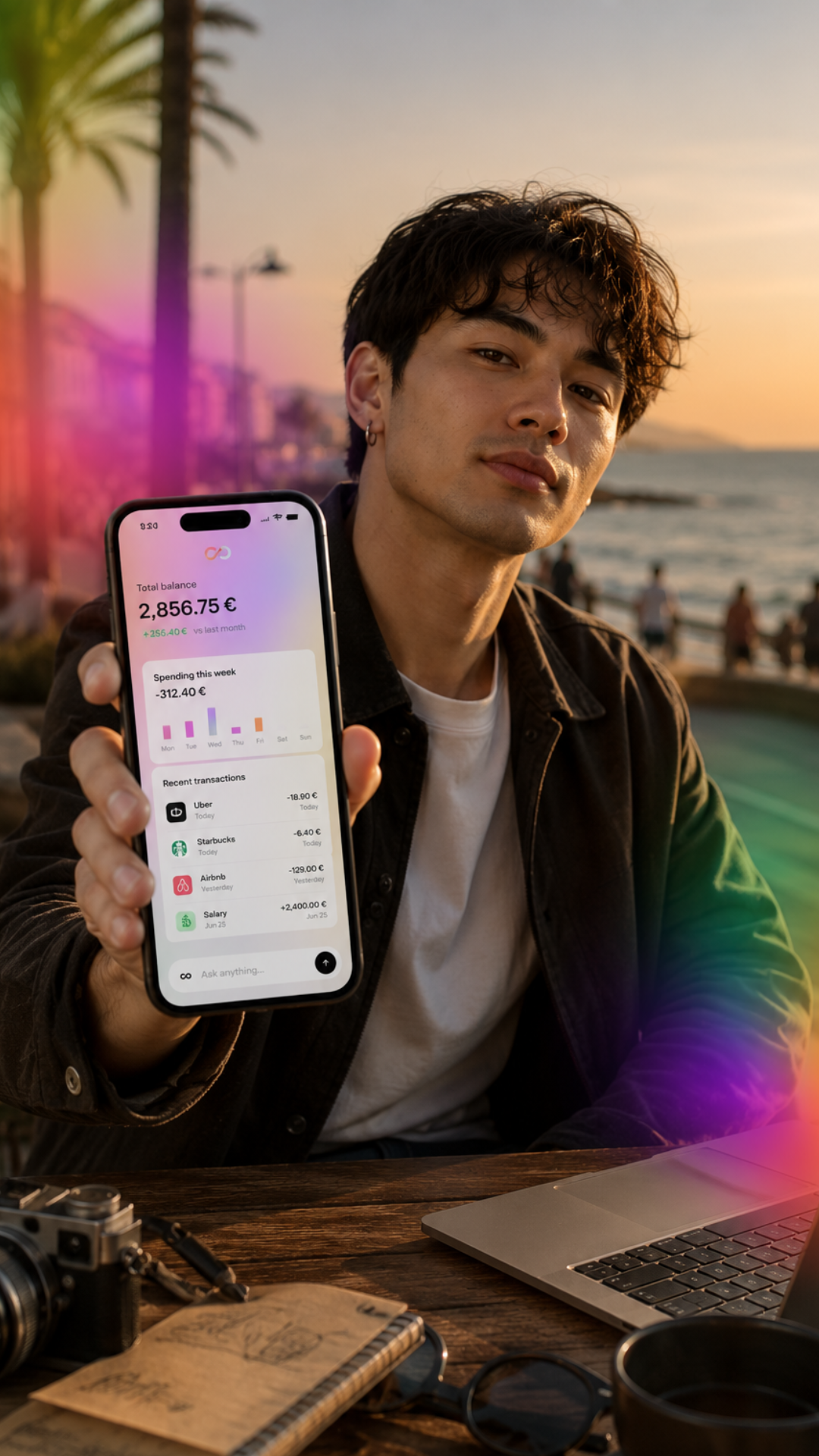 Man at seaside holding phone with balance